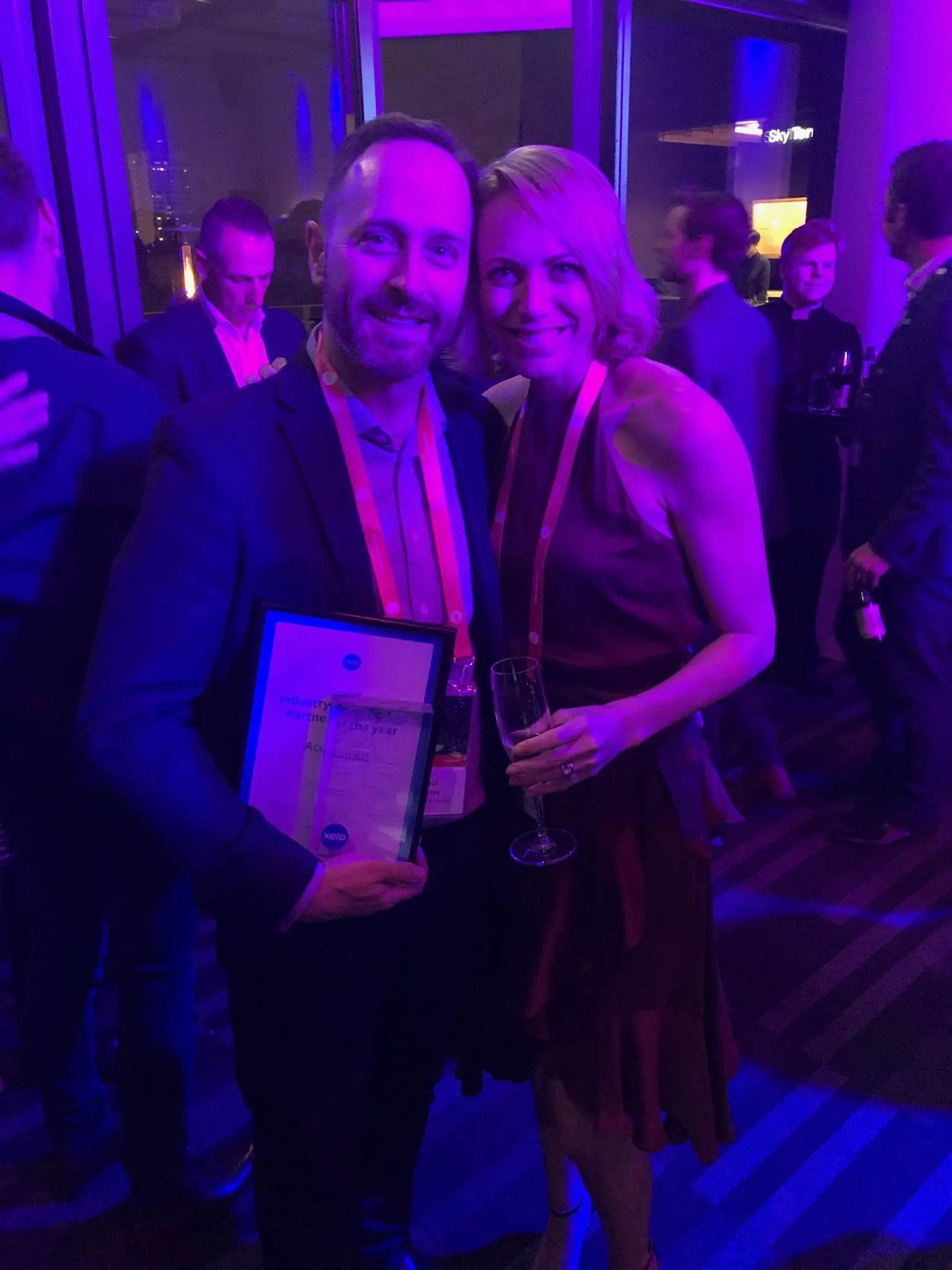 Two AccountKit team members holding the Xero Industry-Specific App Partner of the Year award at the Xero Awards